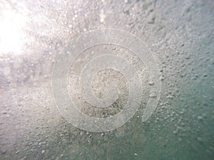 Water background: underwater close-up shot of bubbles inside a s