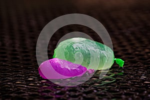 Water balloons remnants outside on wet table