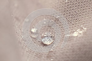 water beading on fabric. Waterproof coating background with water drops. soft focus, blur