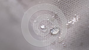 water beading on fabric. Waterproof coating background with water drops. soft focus, blur