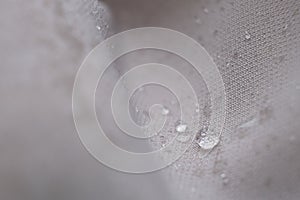 water beading on fabric. Waterproof coating background with water drops. soft focus, blur