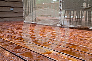 Water beads up on a freshly sealed wood deck after a morning rainstorm at the cottage.