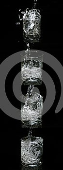 Water being poured into Glass against Black Background