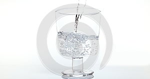 Water being poured into Glass against White Background