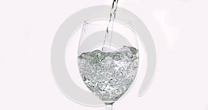 Water being poured into Glass against White Background