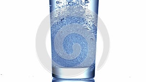 Water being poured into Glass against White Background,