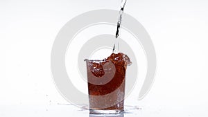 Water being poured into Glass or Red Wine, against White Background