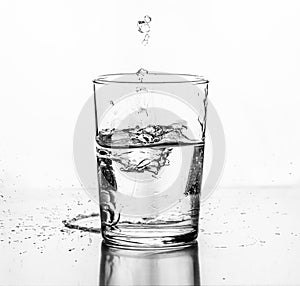 Water being poured into a glass. White background