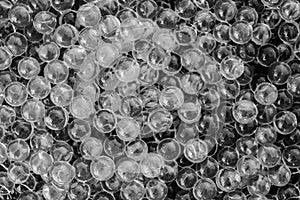 Water black and white gel balls with bokeh. Polymer gel. Silica gel. Balls of black and white hydrogel. Crystal liquid ball with