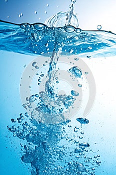 Water blast with bubbles in blue