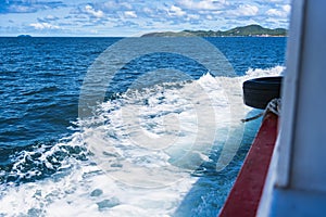 Water blue ocean splash and boat in the sea way ,Waves splashing on the side of ship