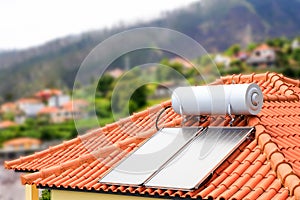 Water boiler with solar panels on roof of house