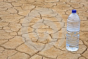 Water bottle on dry ground