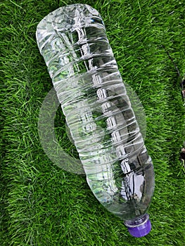 Water bottle on green grass as background