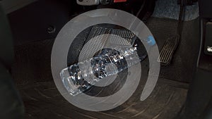 The water bottle rolling hinder car brake ,car safety system on photo