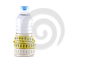 water bottle surrounded by yellow tapeline or measurement tape