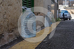 Water bottles in front of a house facade