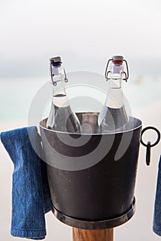 Water bottles in ice bucket at hotel beach