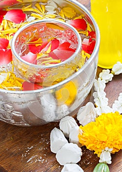 Water in bowl mixed with perfume and vivid flowers corolla , Songkran festival of Thailand