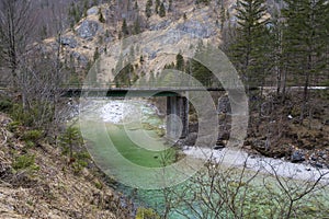 Water bridge over green alpine river