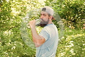 daily water. brutal bearded man drink bottle. mature hipster with beard in forest.