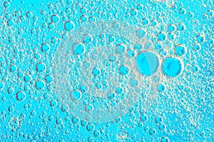 Water bubbles on blue background. Scientific image of cell membrane. Macro up of liquid substances. Abstract molecule atom