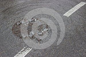 Water bubbling up through manhole cover and sewer