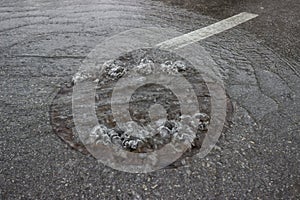 Water is bubbling up through manhole cover and sewer 3