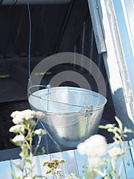Water bucket in the house for a hand well for lifting water from the bowels in a Russian village. Problem with water supply