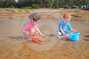 Water and bucket play at the beach