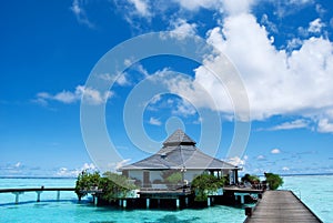 Water bungalows and blue ocean and sunny sky photo