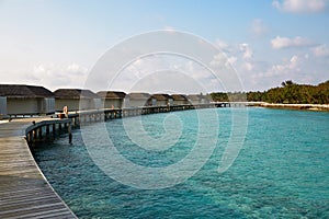 Water bungalows in hotel on Maldives. Villas on Indian ocean at luxury spa resort.