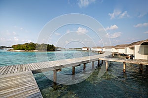 Water bungalows in hotel on Maldives. Villas on Indian ocean at luxury spa resort.