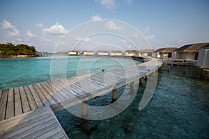 Water bungalows in hotel on Maldives. Villas on Indian ocean at luxury spa resort.