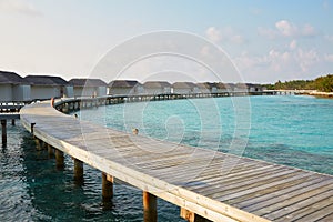 Water bungalows in hotel on Maldives. Villas on Indian ocean at luxury spa resort.