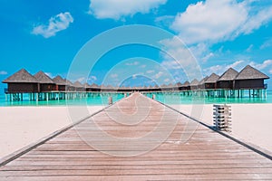 Water bungalows and wooden jetty on Maldives