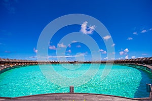 Water bungalows and wooden jetty on Maldives