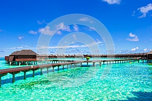 Water bungalows and wooden jetty on tropical