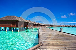 Water bungalows and wooden jetty on tropical