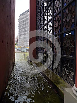 Water canal around monument with metal carved decorative window