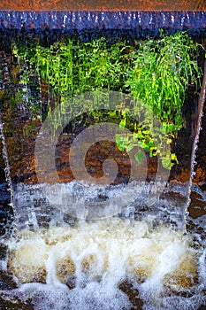 Water cascade in a city park pond