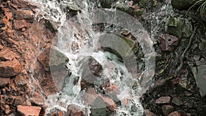 Water cascading down rocks in slow motion