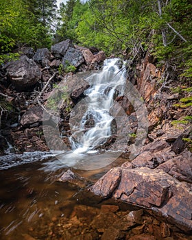 Water cascading down a secluded waterfall in Terra Nova National Park - Newfoundland, Canada.