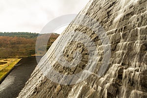 Water cascading down stone dam, Ladybower reservoir.