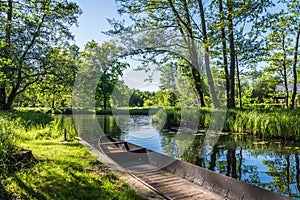 Water channel in the Spreewald Biosphere Reserve in Germany, with one of the typical wooden boats