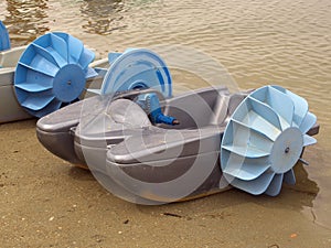 Water children`s catamaran with a wheeled propeller