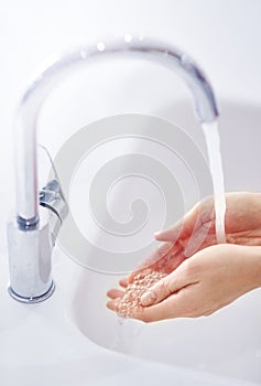 Water, cleaning and washing hands in bathroom for health, hygiene or wellness in home. Fingers, liquid and palm of