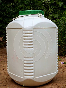 Water container kept on soil land at natural background, household product