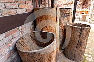 Water containers made of wood. Old barrels carved from the trunk of a tree