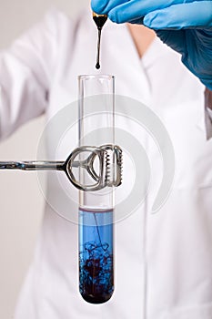 Water contamination test, tube witb blue liquid photo